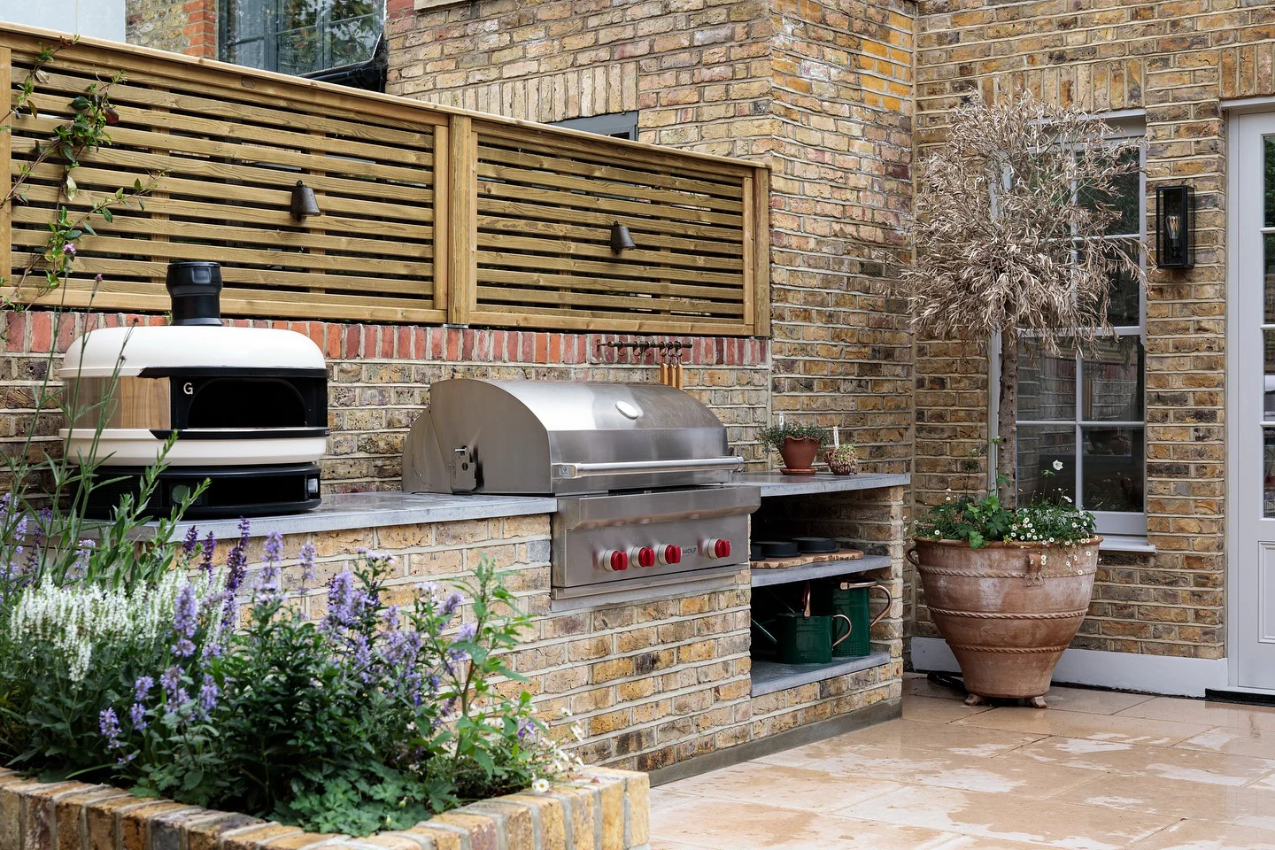 5. Brick Courtyard Outdoor Kitchen in Warm Neutrals & Brushed Stainless (Small Outdoor Kitchen Ideas)