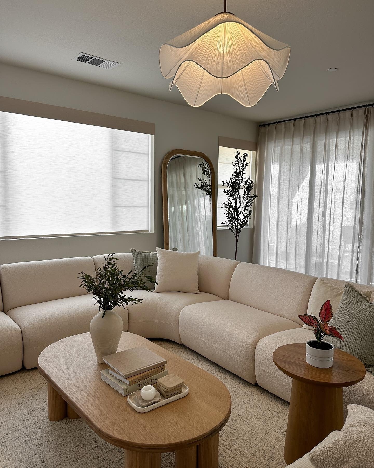 8. Curved Ivory Sectional with Light Wood Warmth (Japandi Living Room Ideas)