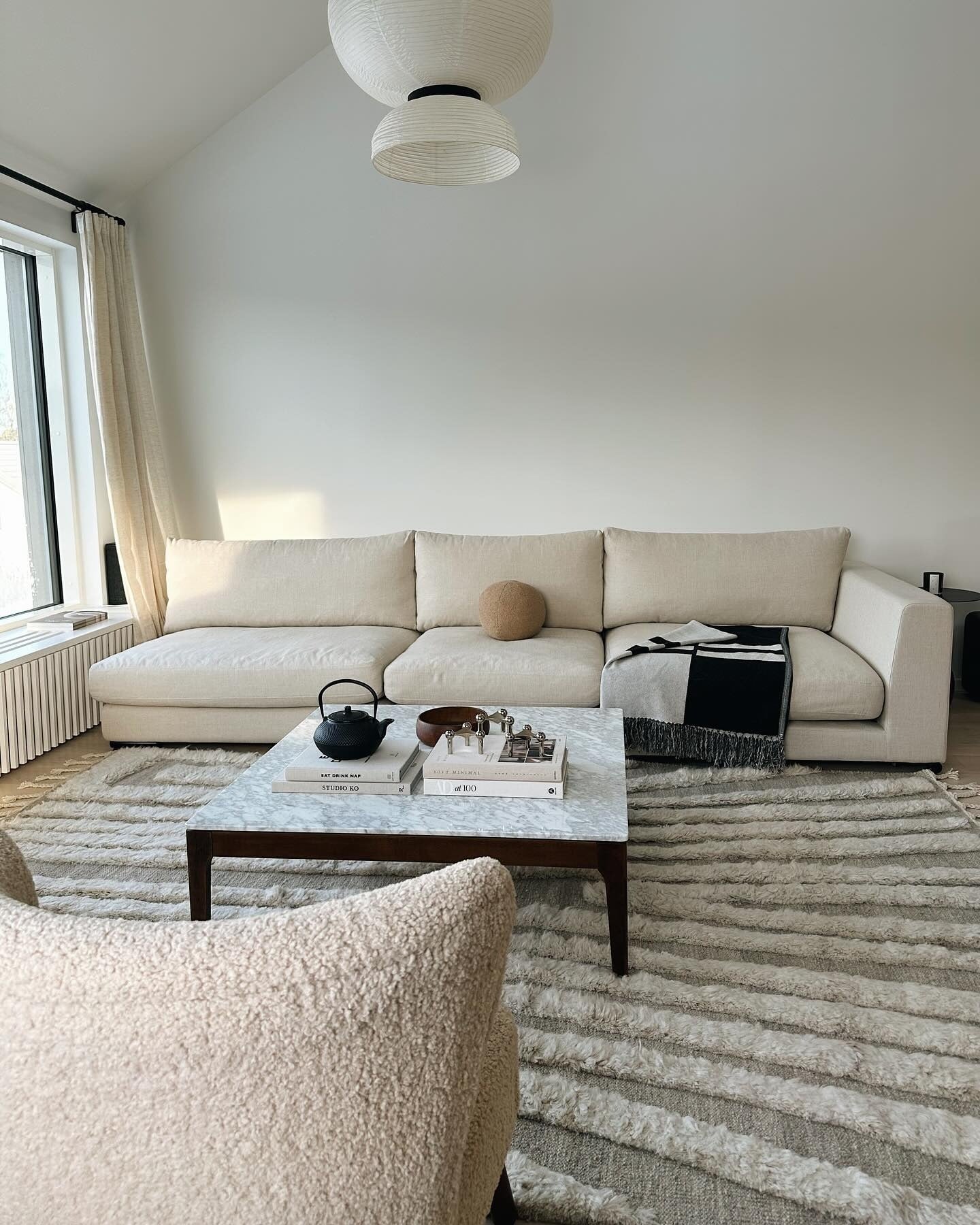 9. Layered Textiles in Cream and Charcoal (Japandi Living Room Ideas)