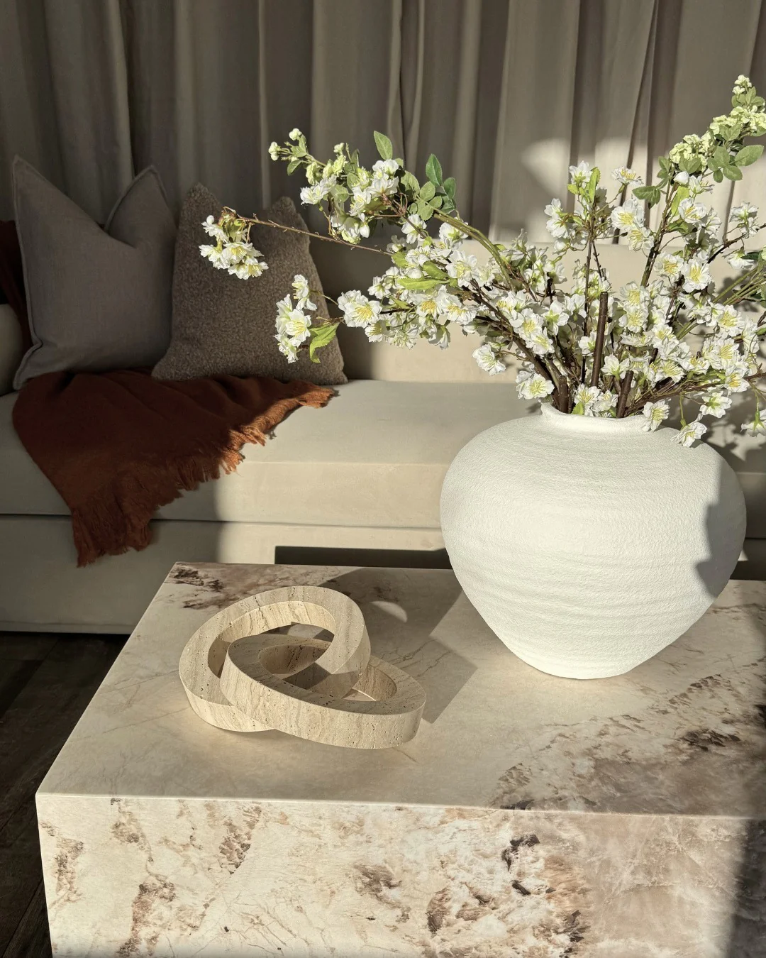 5. Marble and Linen in Earth-Toned Layers (Japandi Living Room Ideas)