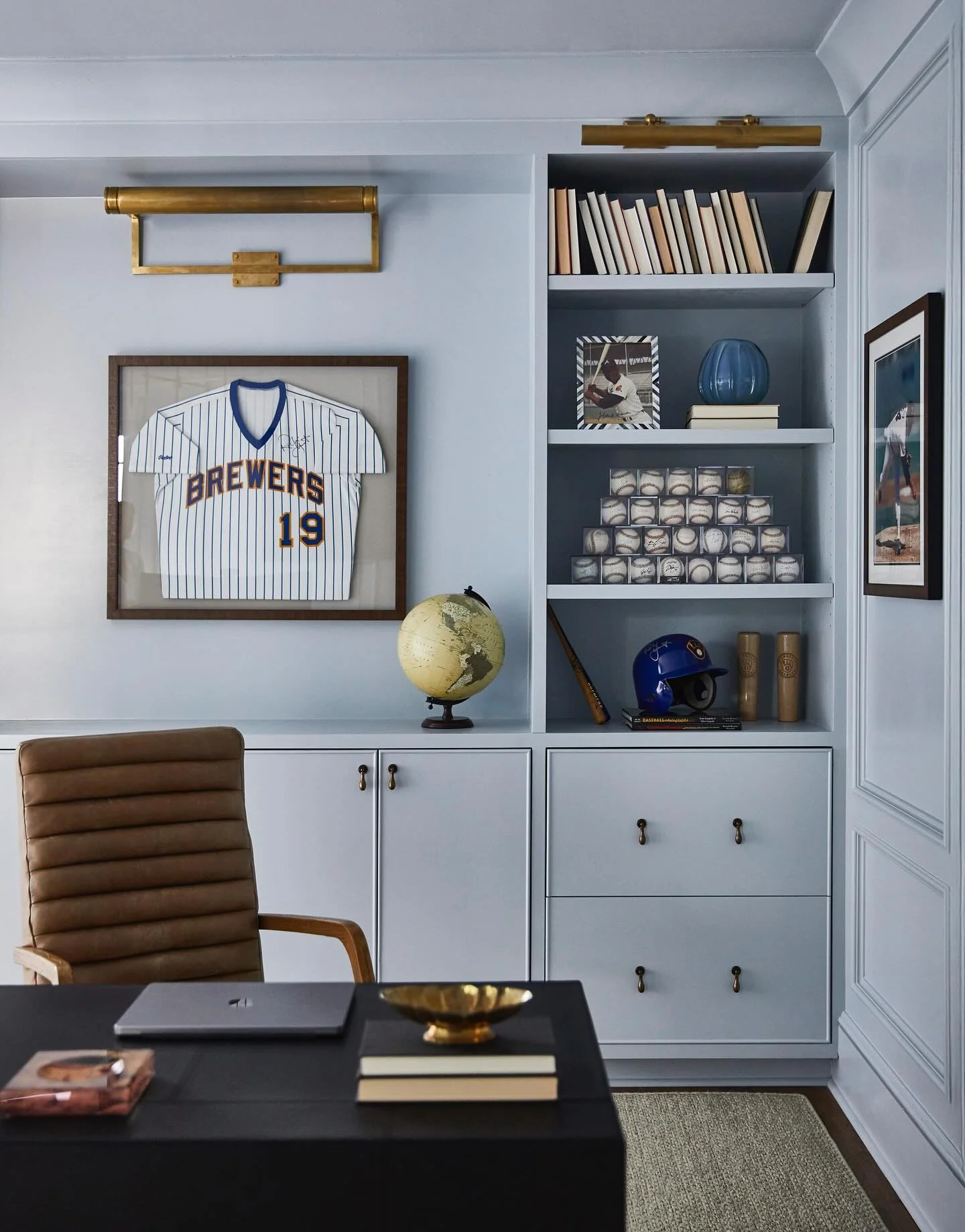 12. Light Blue Built-In Office Wall with Brass Picture Lights and Sports Display (Light Blue Office Ideas)