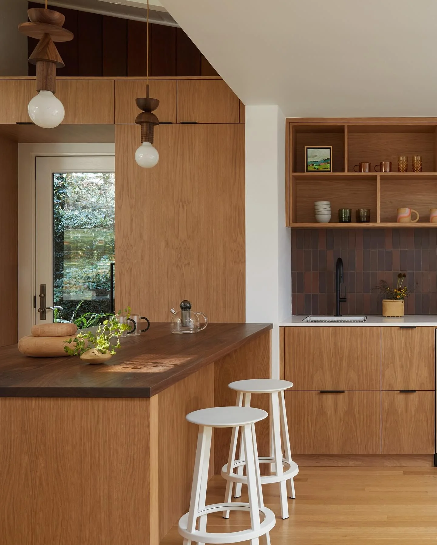 1. Scandinavian Minimalism with Rich Wood and White Accents (Brown Kitchen Cabinets Ideas)