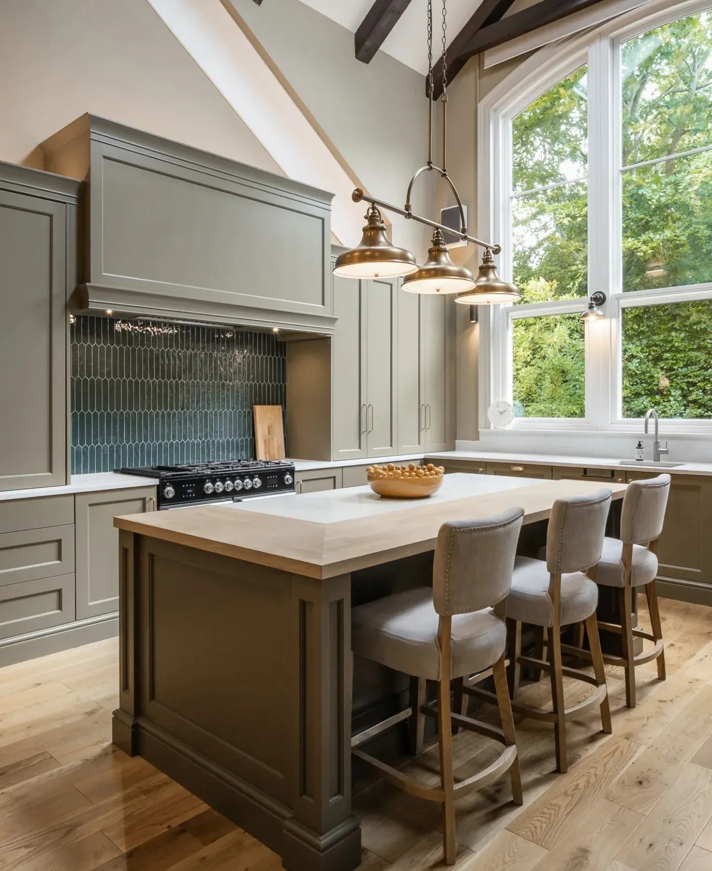 15. Classic Green Kitchen with Tall Windows and Statement Lighting (High Ceiling Kitchen Ideas)