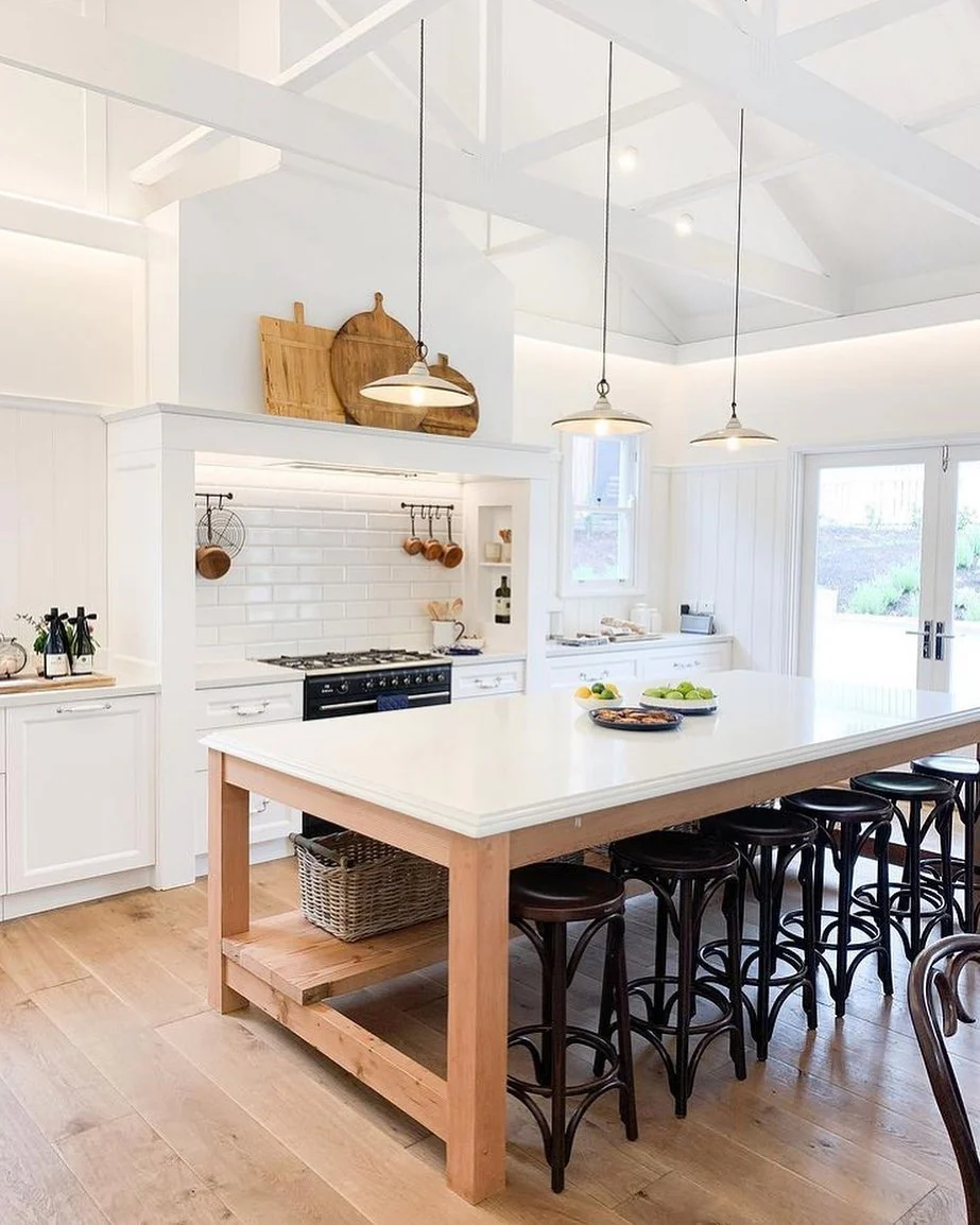 8. Airy White Farmhouse Pendant Lighting with Soft Neutrals + Long Island Seating (Farmhouse Kitchen Lighting Ideas)
