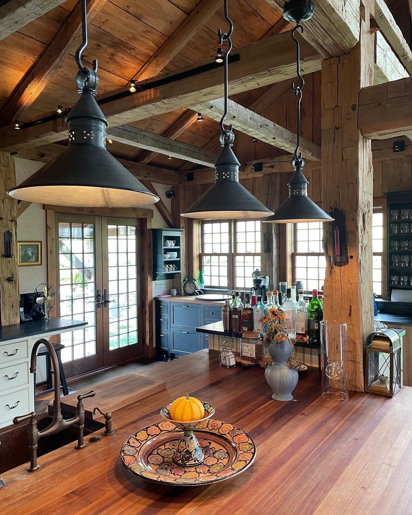 14. Matte Black Barn Pendants with Exposed Beams + Rich Walnut Counters (Farmhouse Kitchen Lighting Ideas)