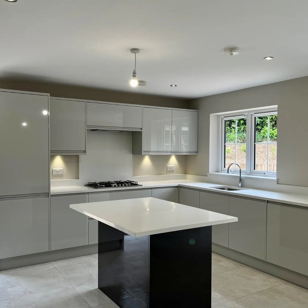 1. Glossy Light Grey Slab Cabinets with Waterfall Island (Light Grey Kitchen Cabinets Ideas)