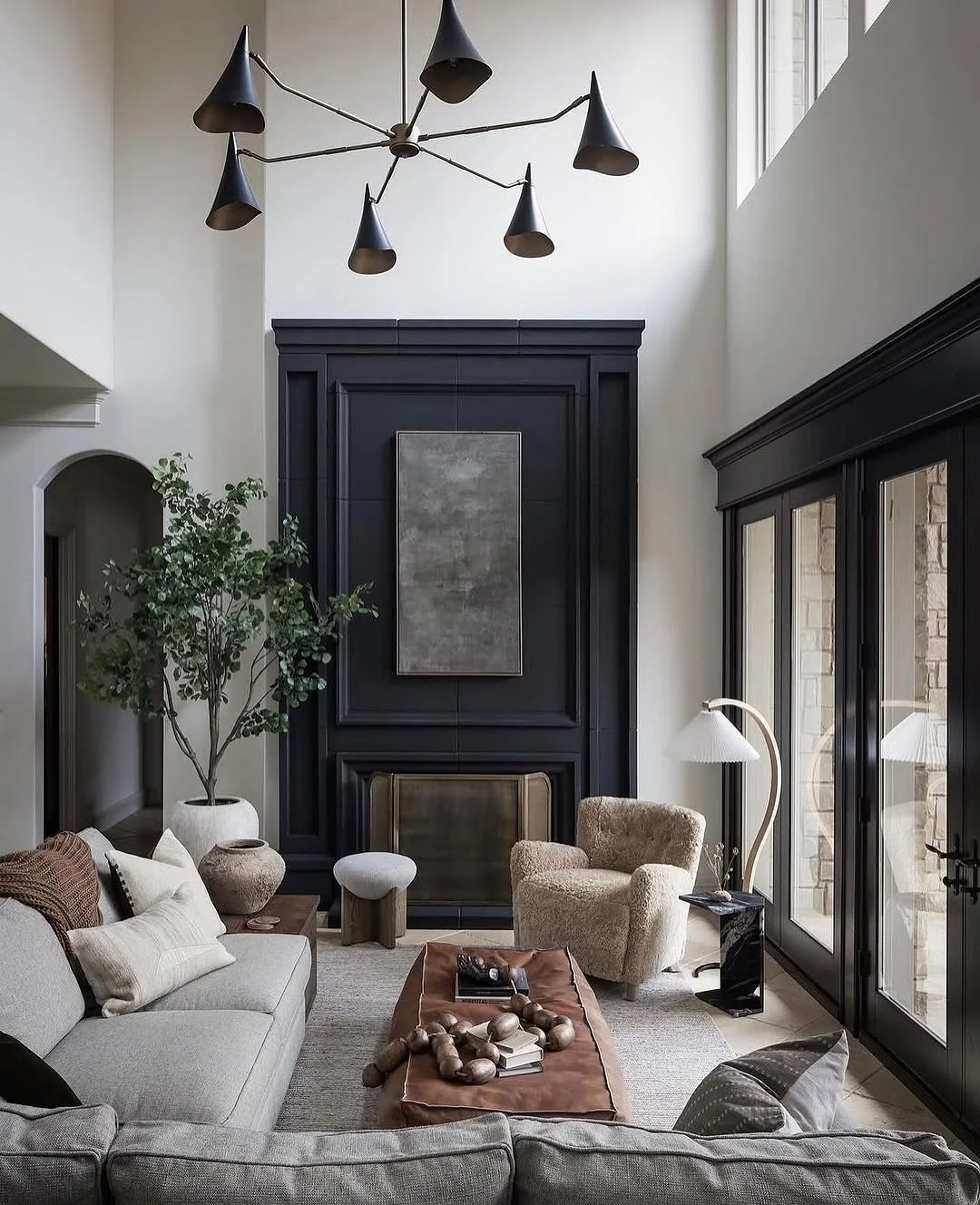 12. Black Fireplace Feature with Layered Browns and Textured Seating (Brown and Black Living Room Ideas)